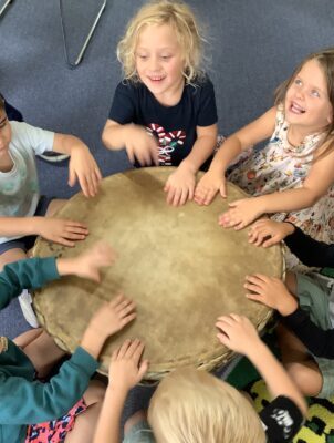Kids are in the activity and put their hands on the table